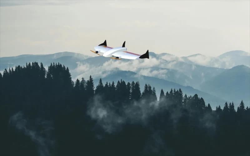 Supplied WING aircraft design render above forested mountains
